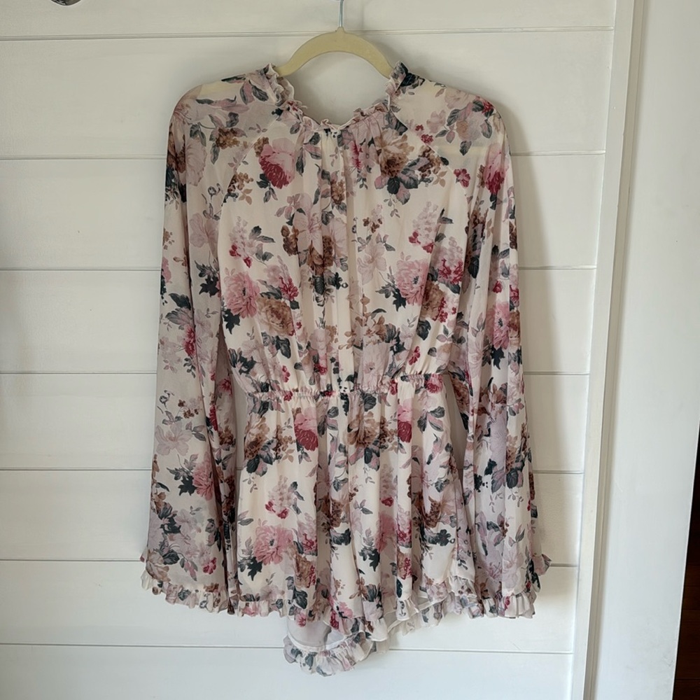 Cream and floral romper with 70s style flutter sleeves